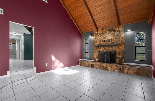 unfurnished living room featuring beamed ceiling, a fireplace, light tile patterned floors, and wooden ceiling