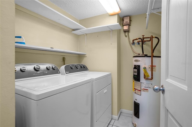 washroom featuring a textured ceiling, electric water heater, separate washer and dryer, and light tile patterned floors