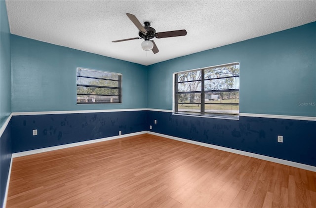 spare room featuring a textured ceiling, ceiling fan, and hardwood / wood-style floors