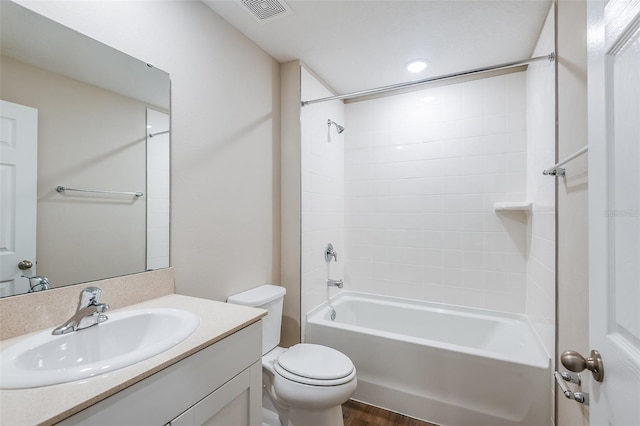 bathroom featuring shower / tub combination, toilet, wood finished floors, vanity, and visible vents