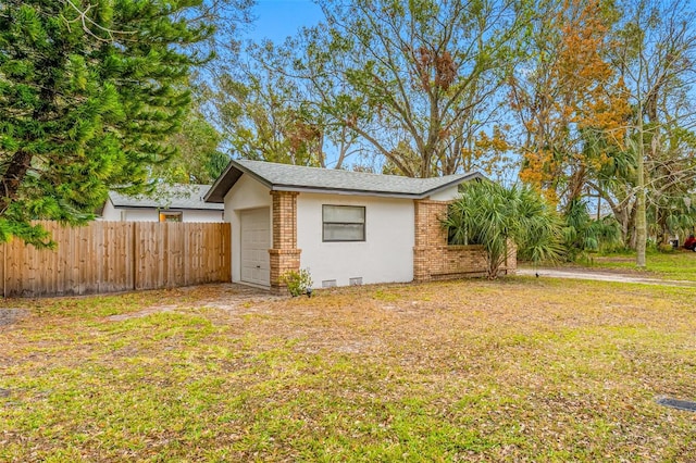 view of property exterior featuring a lawn and a garage