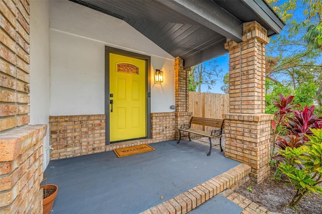 view of exterior entry with covered porch