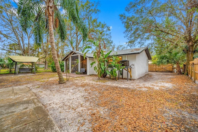 view of front facade featuring a sunroom and a carport