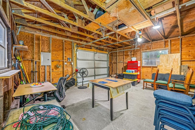 garage with electric panel and a garage door opener