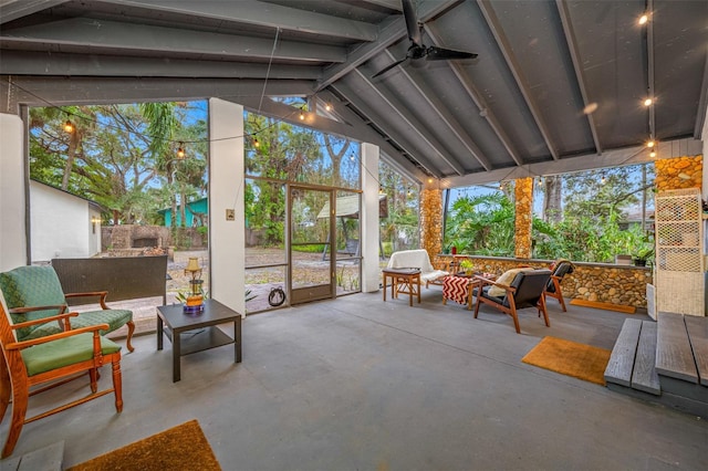 sunroom / solarium featuring ceiling fan, plenty of natural light, and vaulted ceiling