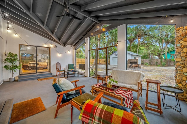 sunroom featuring lofted ceiling with beams