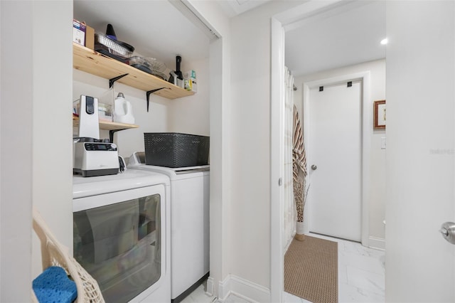 clothes washing area featuring washer and dryer