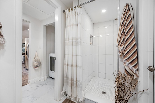 bathroom with curtained shower and washer / dryer