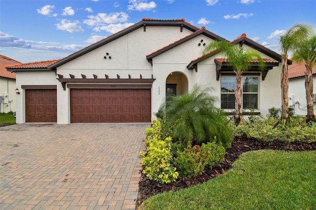 mediterranean / spanish-style house featuring a garage