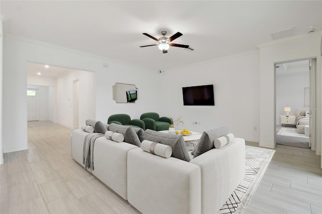 living room featuring ornamental molding and ceiling fan