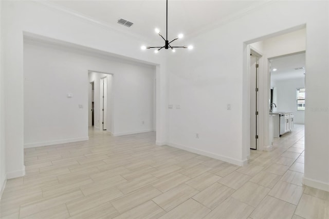 empty room featuring an inviting chandelier and crown molding