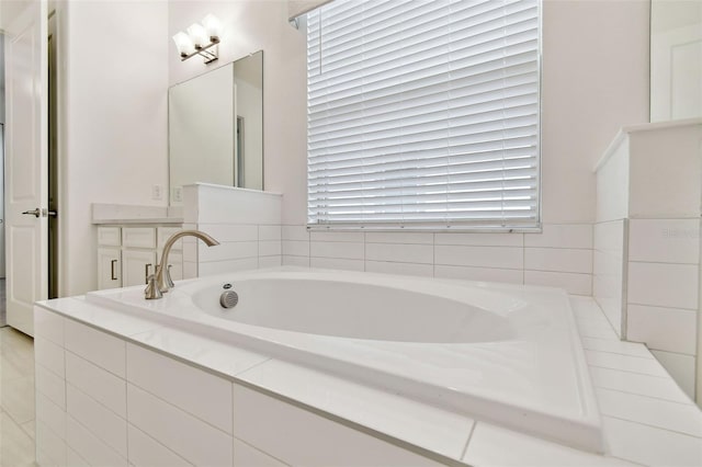 bathroom with a relaxing tiled tub and vanity