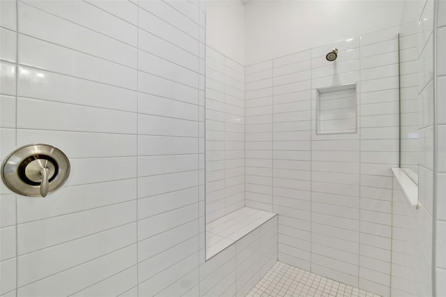 bathroom with a tile shower