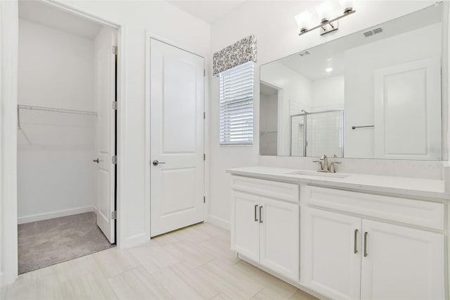 bathroom featuring vanity and a shower with shower door