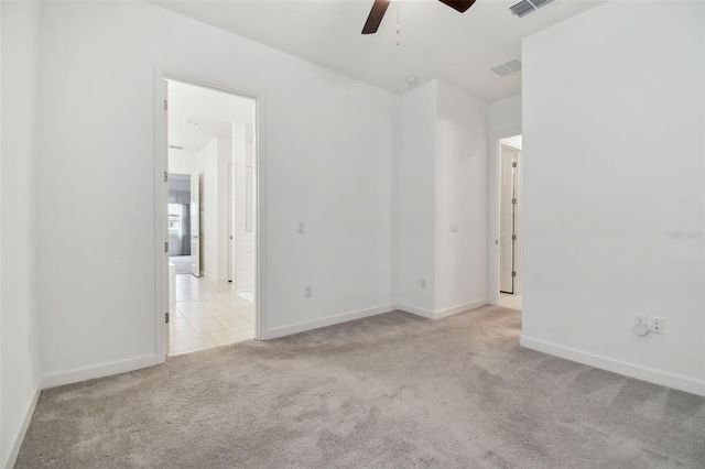 carpeted spare room with ceiling fan