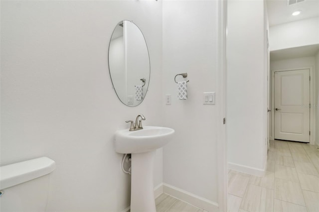 bathroom featuring tile patterned flooring, sink, and toilet