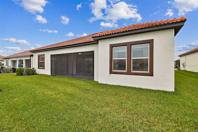 rear view of house with a yard