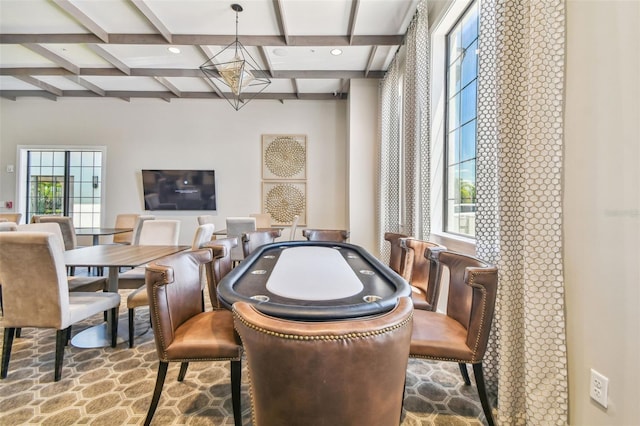 dining room featuring beamed ceiling, coffered ceiling, and a wealth of natural light