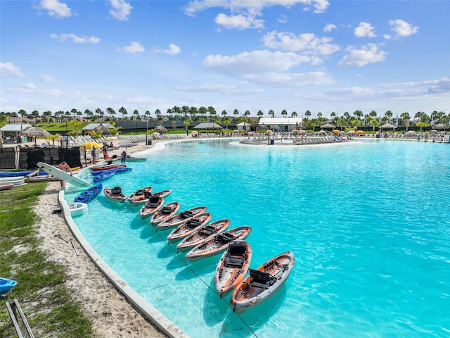 view of swimming pool featuring a water view