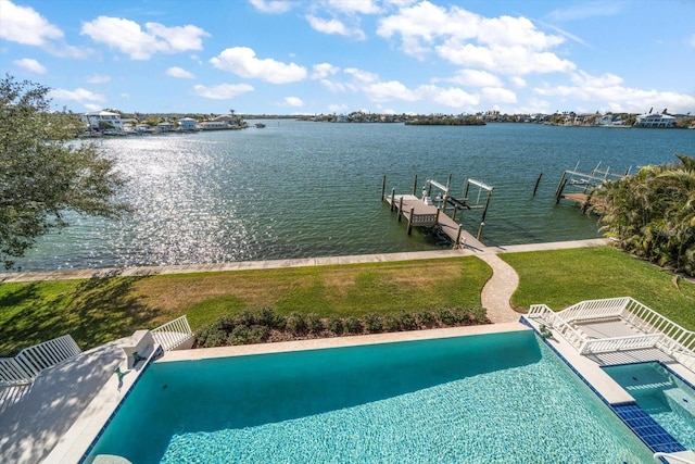 view of pool featuring a lawn, a water view, and a dock