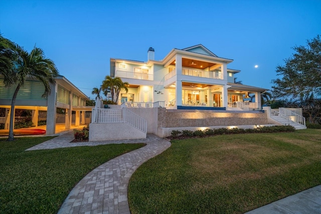 modern home with a yard, a balcony, and a patio