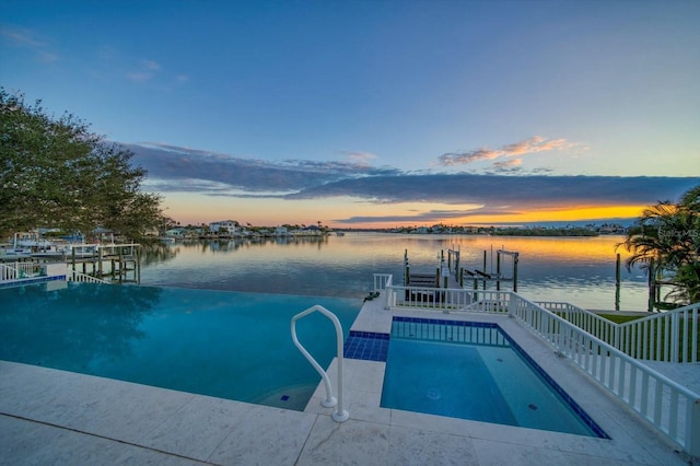 pool at dusk featuring a water view and a boat dock