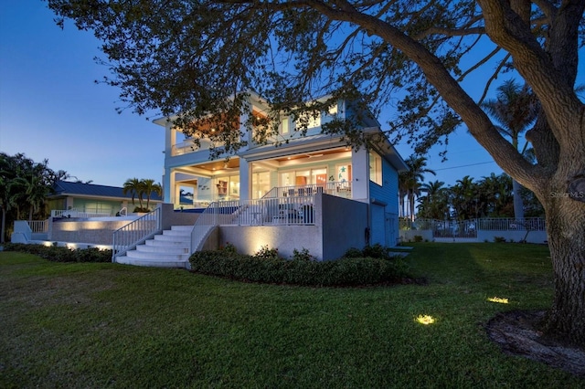 exterior space with a yard and ceiling fan