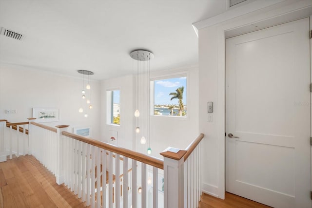 corridor with light hardwood / wood-style floors