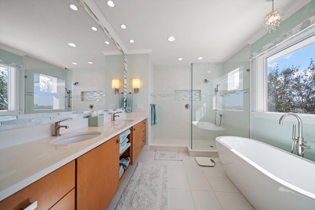 bathroom featuring vanity, a healthy amount of sunlight, shower with separate bathtub, and an inviting chandelier