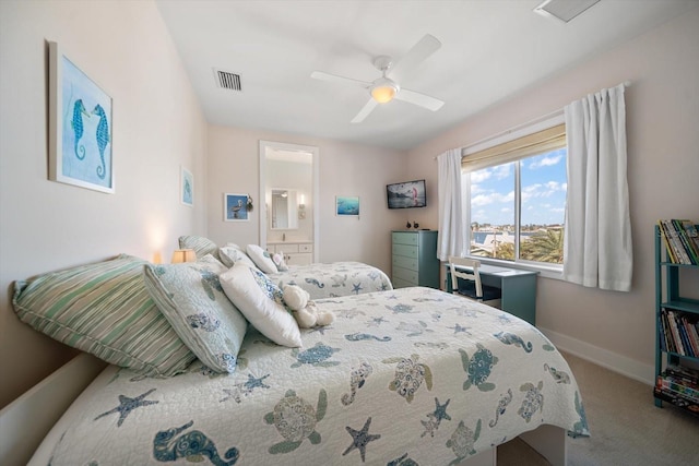 carpeted bedroom featuring ensuite bath and ceiling fan