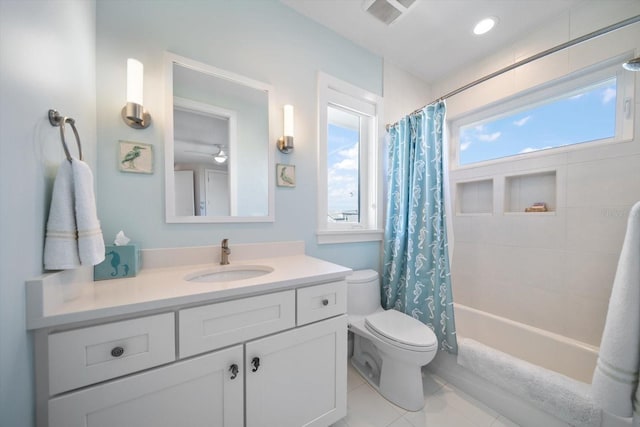 full bathroom with tile patterned floors, shower / bath combo with shower curtain, vanity, and toilet