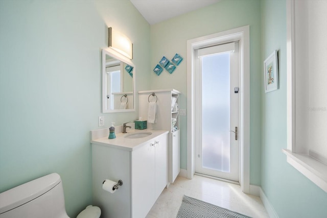 bathroom with tile patterned flooring, vanity, and toilet