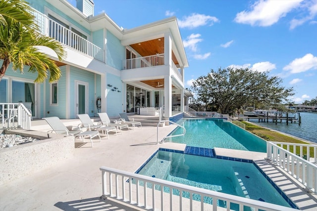 view of swimming pool featuring a patio area and a water view