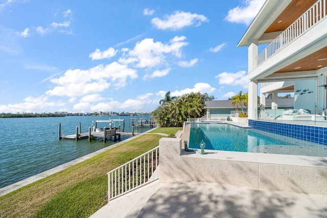 view of pool featuring a yard, a water view, a patio, and a boat dock