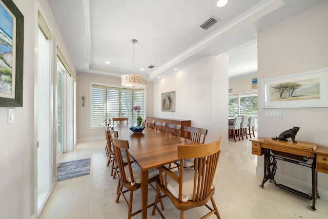 dining room with a raised ceiling