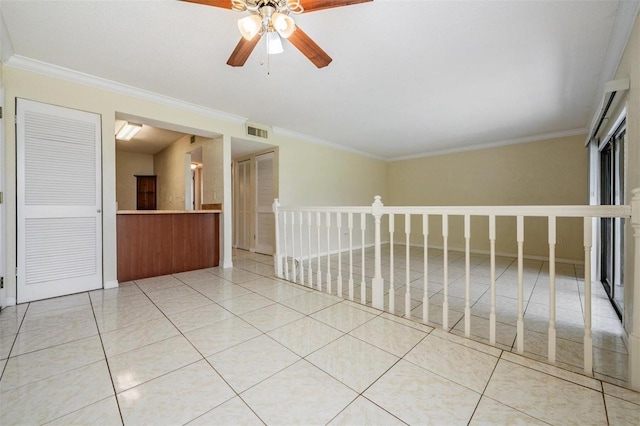 unfurnished room with tile patterned flooring, ceiling fan, and crown molding