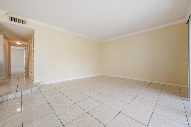 tiled spare room featuring crown molding