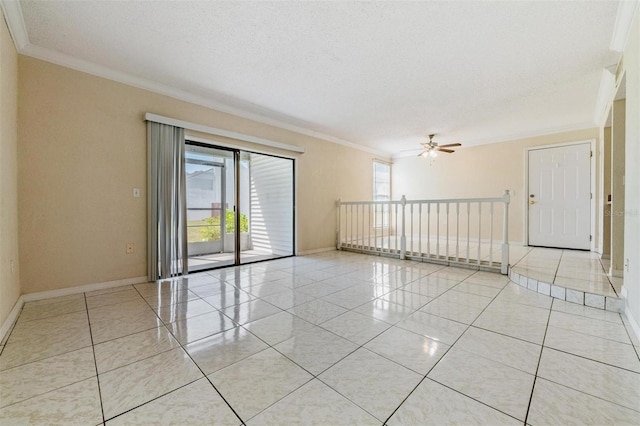 empty room with ceiling fan, light tile patterned flooring, ornamental molding, and a textured ceiling