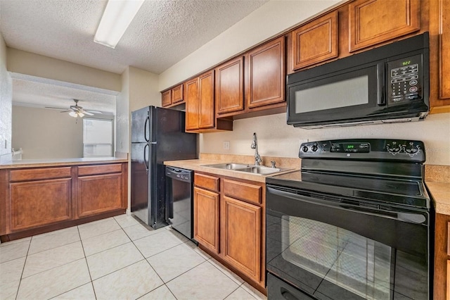 kitchen featuring ceiling fan, sink, a textured ceiling, light tile patterned floors, and black appliances