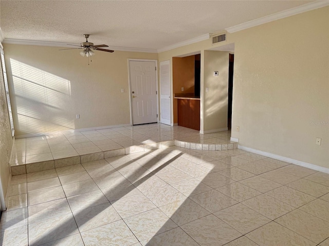 tiled spare room with ceiling fan, ornamental molding, and a textured ceiling