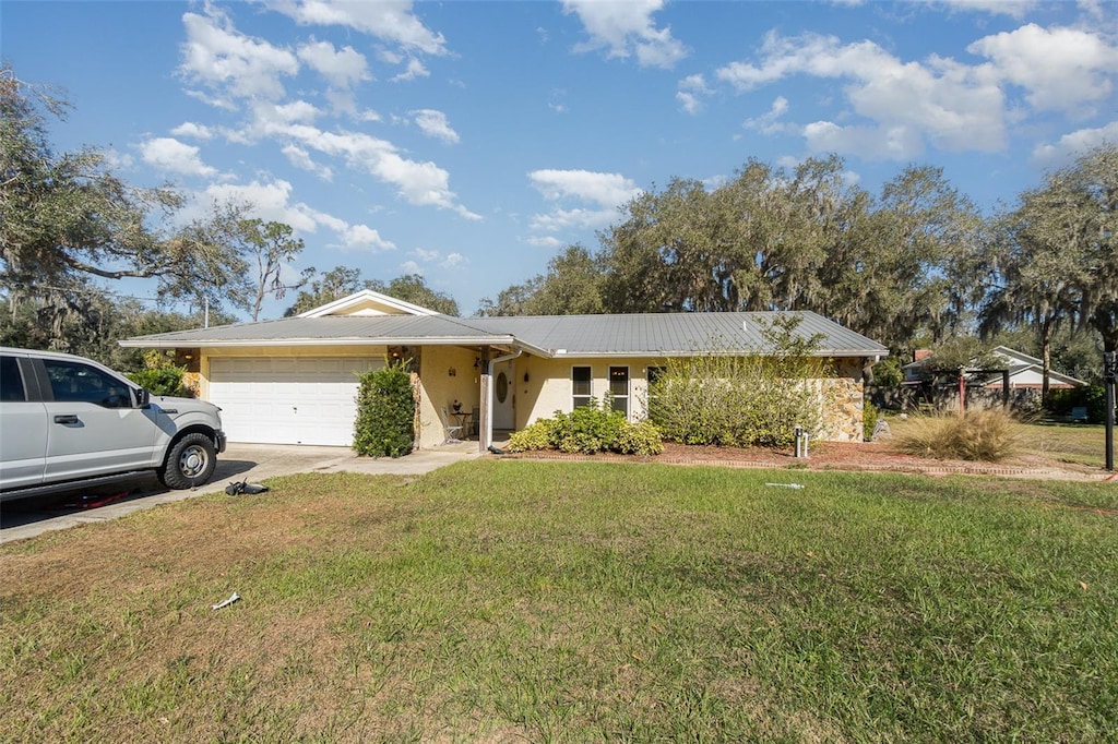 ranch-style home featuring a front yard and a garage