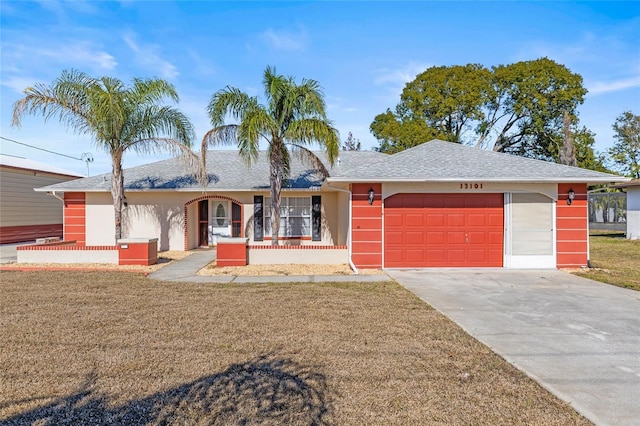 single story home featuring covered porch, a front yard, and a garage