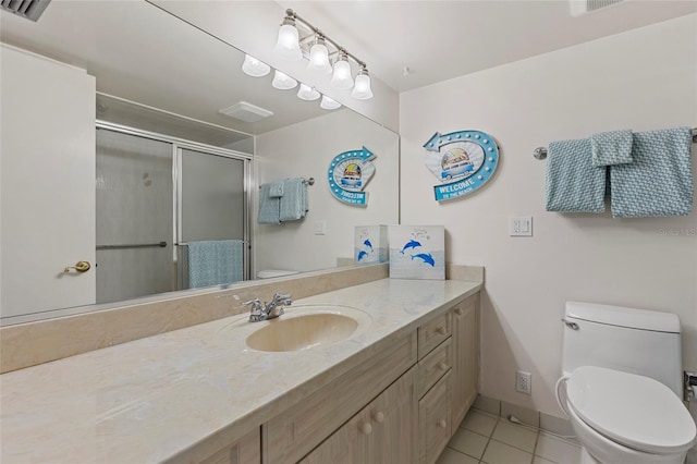 bathroom with toilet, an enclosed shower, tile patterned floors, and vanity