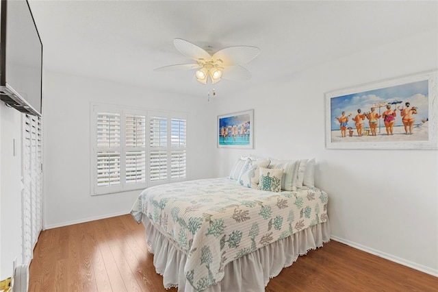 bedroom with ceiling fan and hardwood / wood-style floors