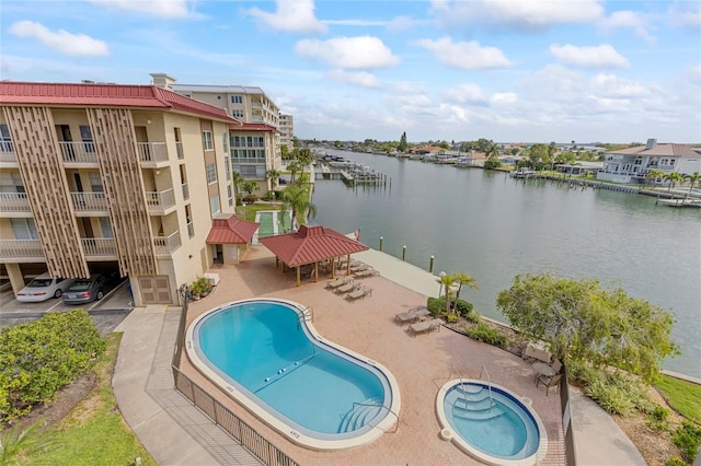 view of swimming pool with a patio, a water view, and a gazebo