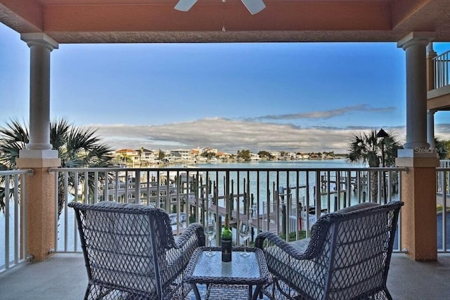 balcony with ceiling fan and a water view