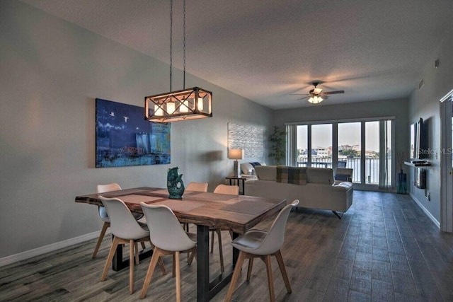 dining space featuring a textured ceiling, ceiling fan, and dark hardwood / wood-style floors