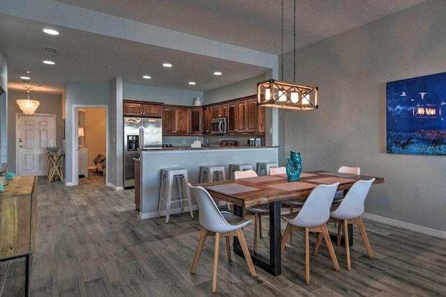 dining area with dark hardwood / wood-style flooring