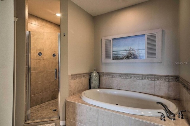 bathroom featuring shower with separate bathtub