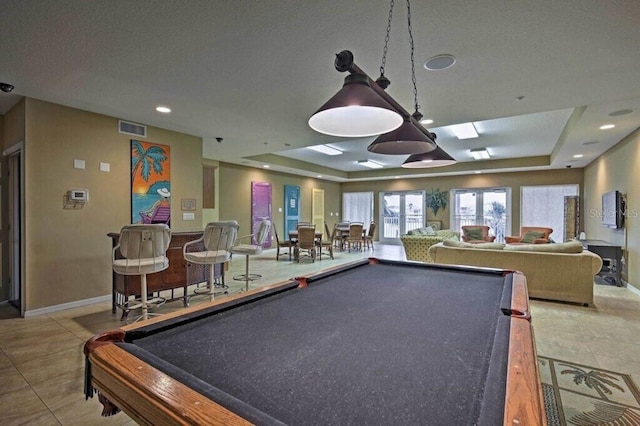 recreation room with light tile patterned floors, a tray ceiling, and pool table